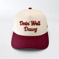 Cap with 'Doin' Well Dawg' text on a white background