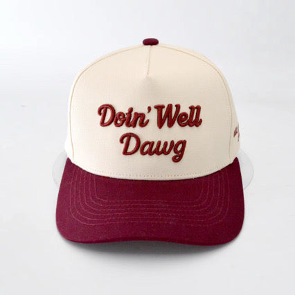 Cap with 'Doin' Well Dawg' text on a white background