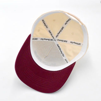 Maroon cap with white interior and brand logo on a white background