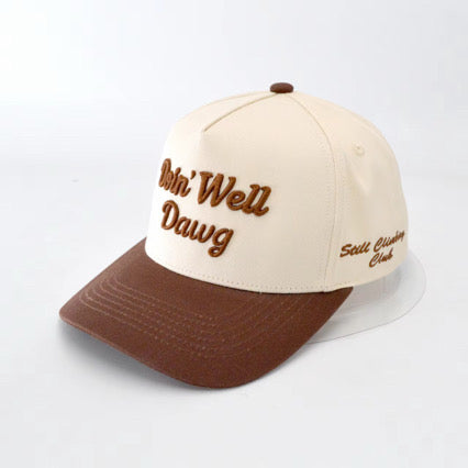 Beige and brown cap with embroidered text on a light gray background