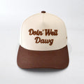 Cap with 'Doin' Well Dawg' text on a white background