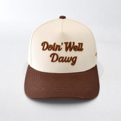 Cap with 'Doin' Well Dawg' text on a white background